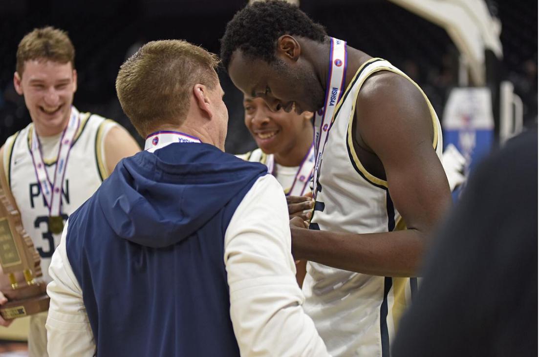 Sekou Cisse (45) (CQ) Principia center, looks at his championship medal