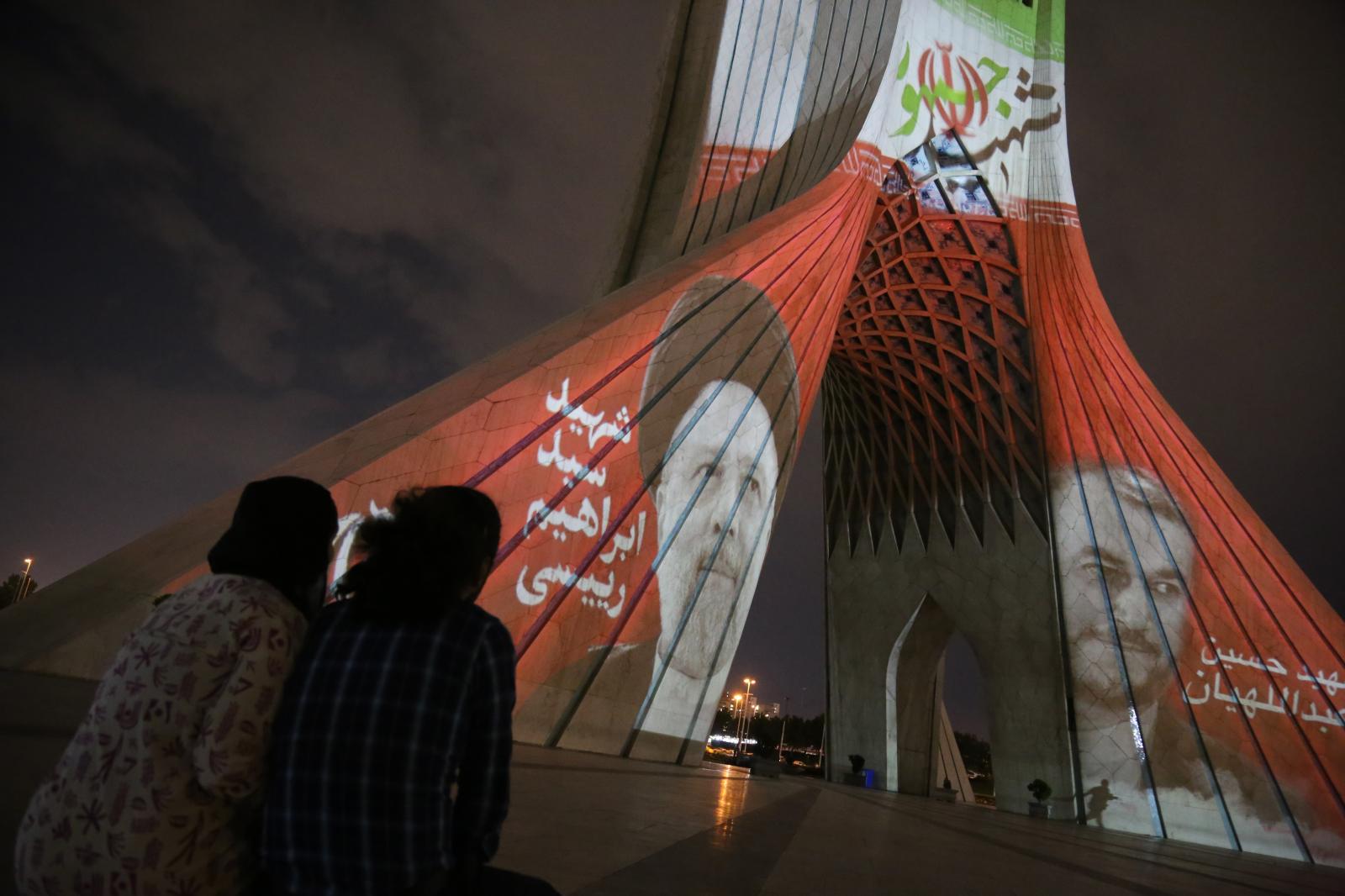 An Iranian couple looks at a vi...of public mourning. Tehran Iran