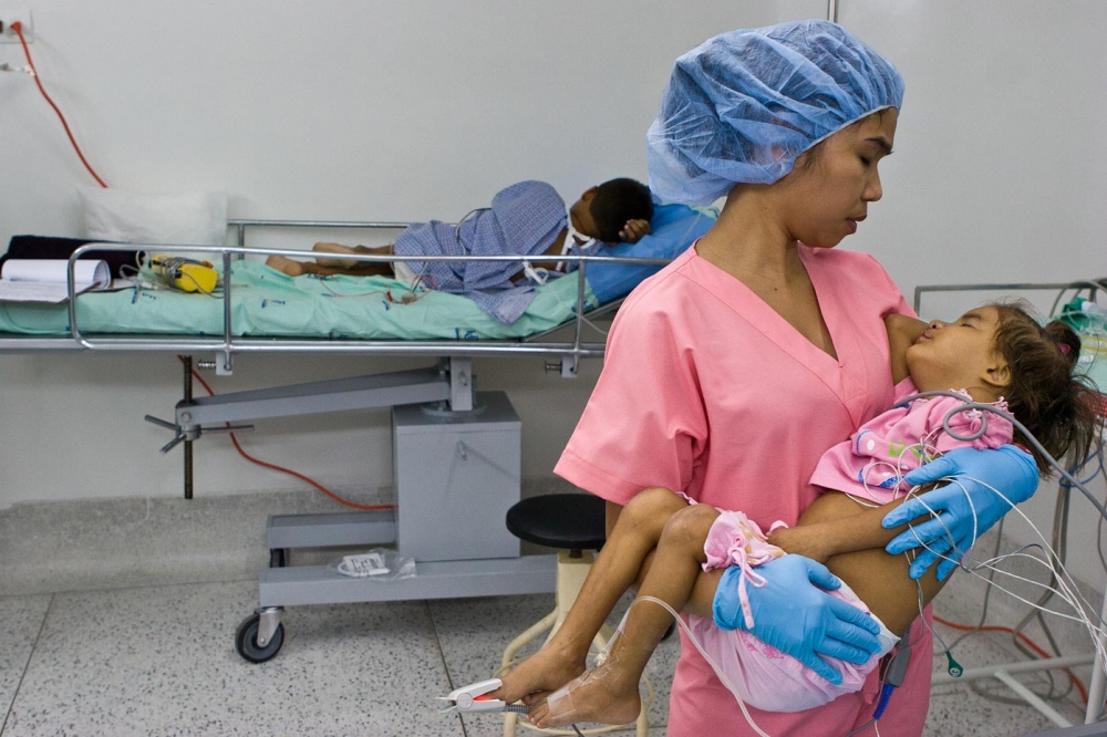 Image from Medical Missions - Elaine Suderio-Tirone, RN comforts a patient in the...