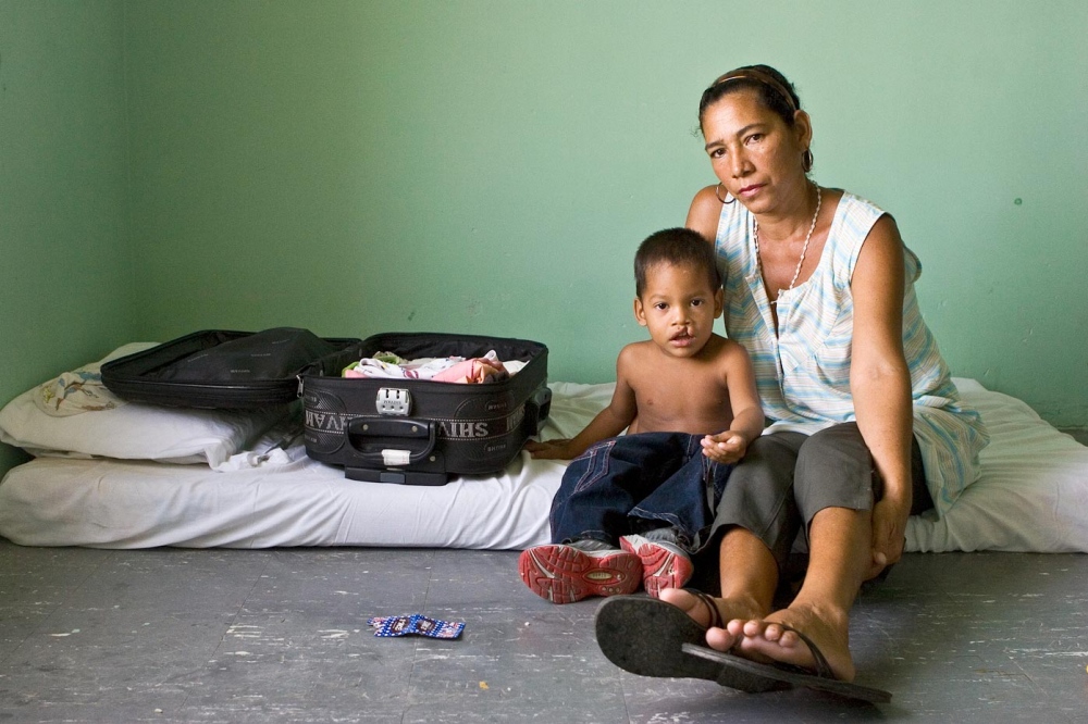 Cesar Comilo with his mother Santa Marta, Colombia, 2007  Some families travel for days to see the doctors. The hospital in Colombia allows them to stay for the whole week while they wait for their surgeries, providing mattresses to sleep on and 3 meals per day.   For Healing the Children Northeast  