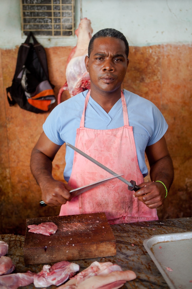  Butcher in Havana market. Cubans procure their groceries from small markets in local...