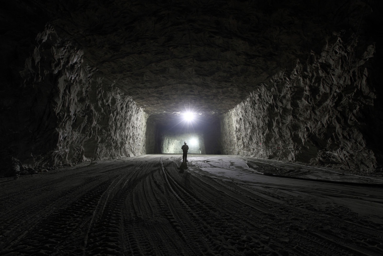 SALT - A Romanian miner stands inside the vast mine shafts of...
