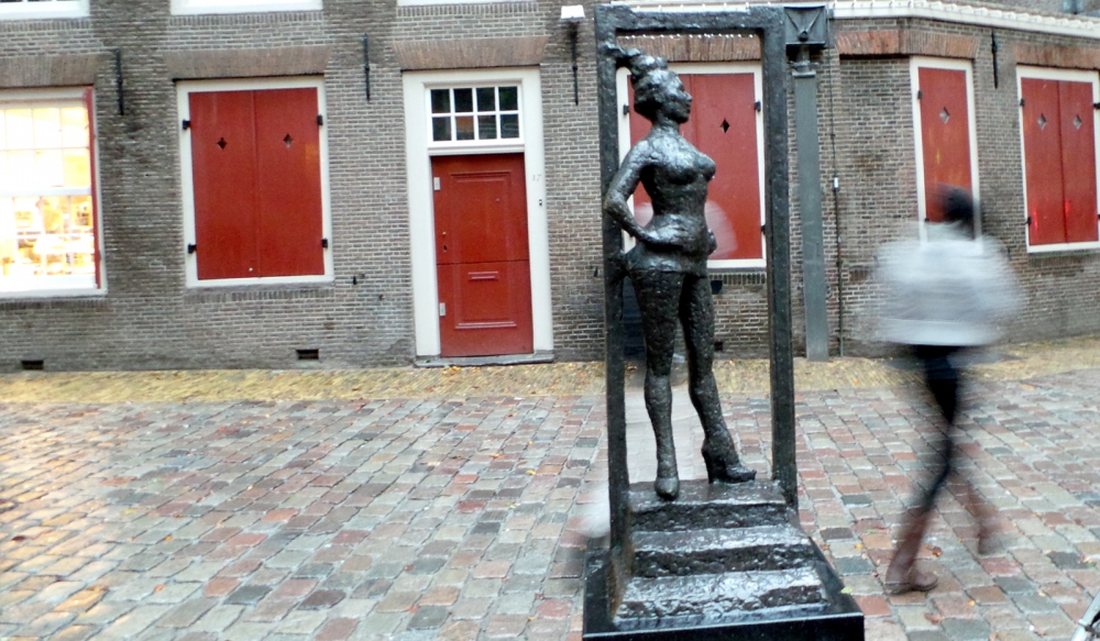  TitledÂ  Belle , the statue depicts a full-breasted woman who, feet apart and standing in a doorway at the top of a small set of steps, looks self-assuredly into the world. The statue is meant to show respect to the millions of people around the world who earn their money in prostitution.  