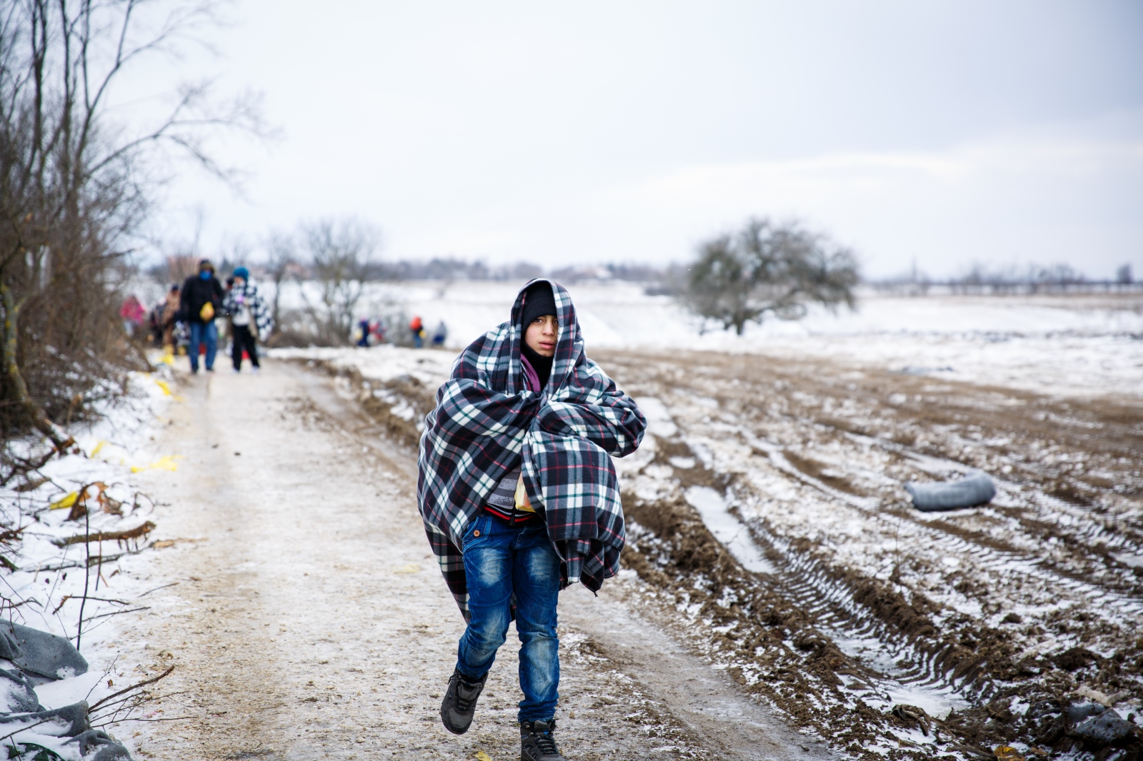 Crossing Serbia - In subfreezing snowy weather, a refugee child walks the...