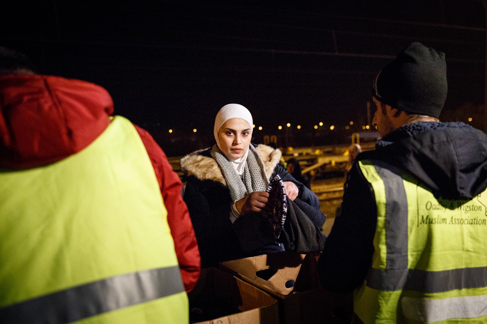 Crossing Serbia -   A Syrian woman collects warm accessories, donated by...