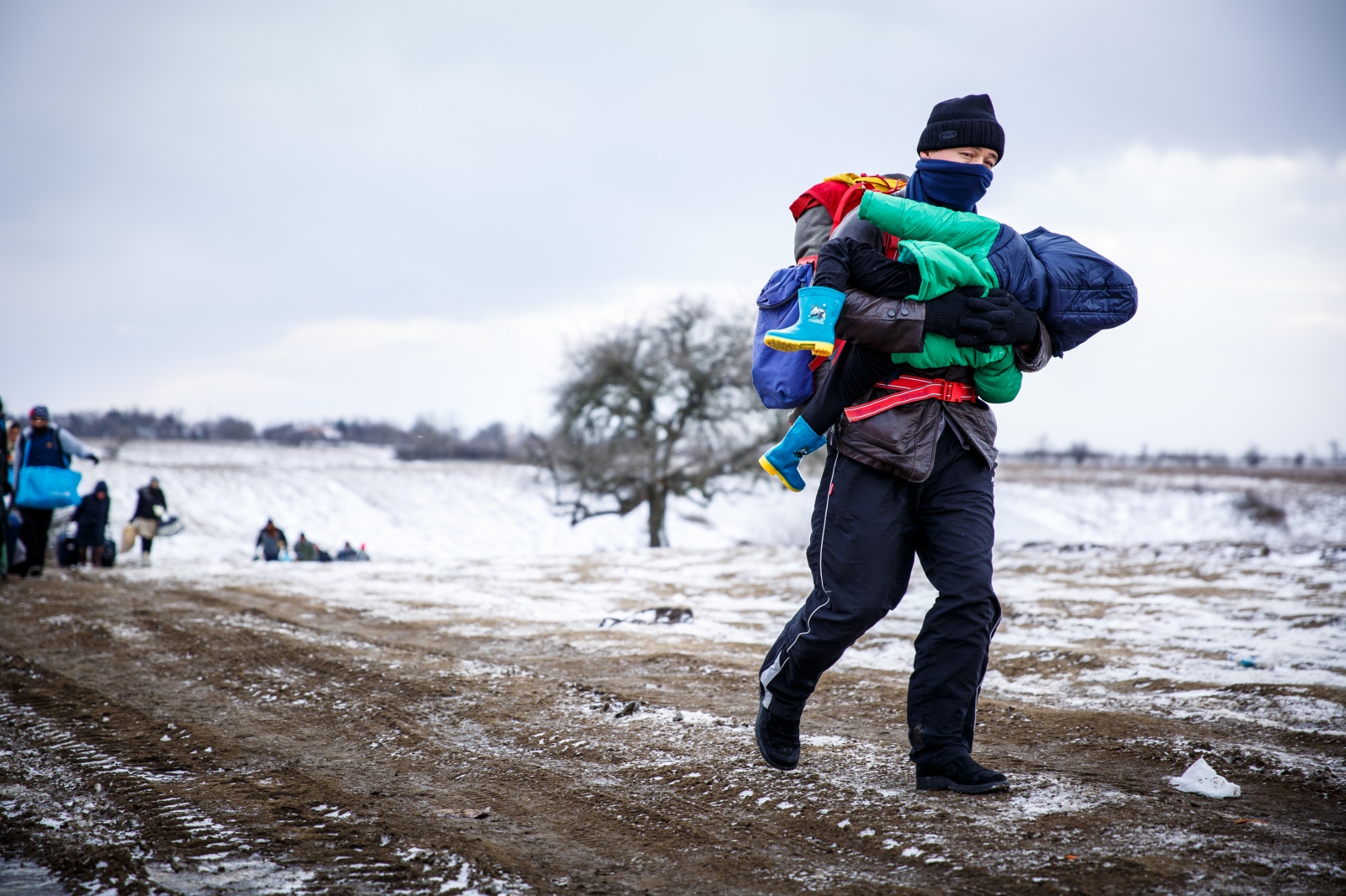 Crossing Serbia - In subfreezing snowy weather, a refugee walk the...