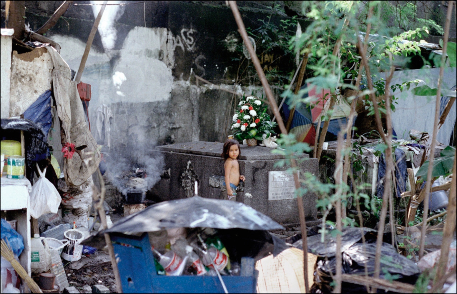 Girl Amidst Her Family's Belongings, South Cemetery, Manila, Philippines, November 2005