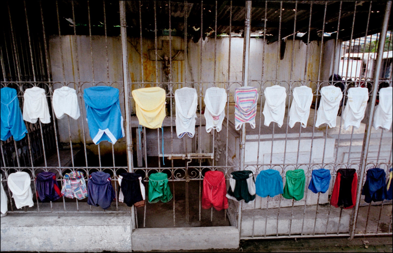 Philippines, Cemeteries -                  Childrenâ€™s Laundry Hanging on Gate,...