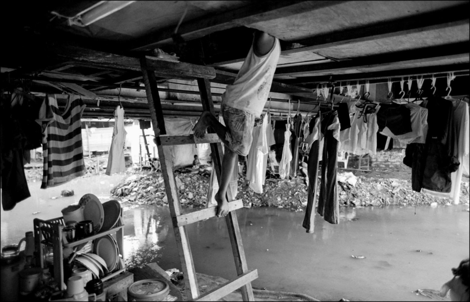 Philippines, Slums -  Legs on Ladder, Pandacan Bridge, Manila, Philippines,...