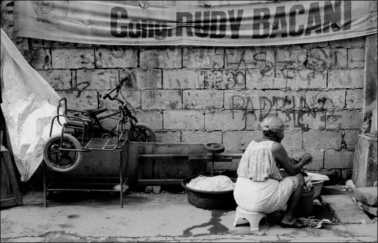 Philippines, Slums -  Woman Doing Laundry By Wall, Santa Mesa Station,Manila,...