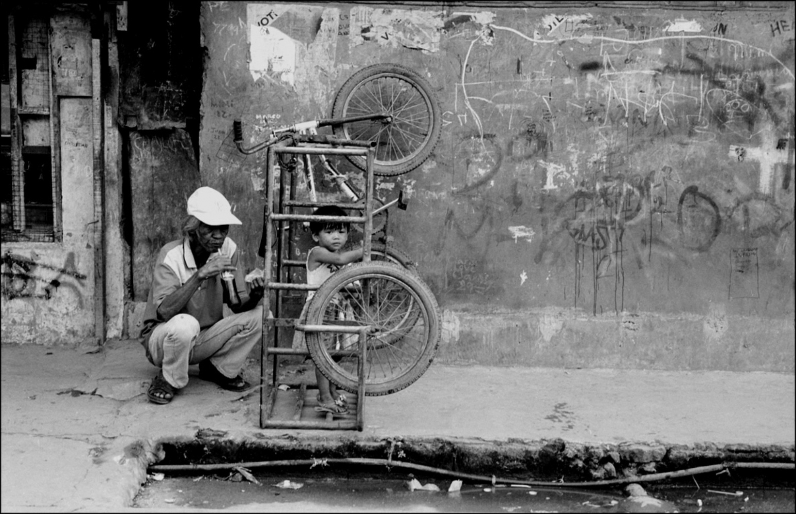 Philippines, Slums -  Man, Child and Bicycle, Santa Mesa Station, Manila,...