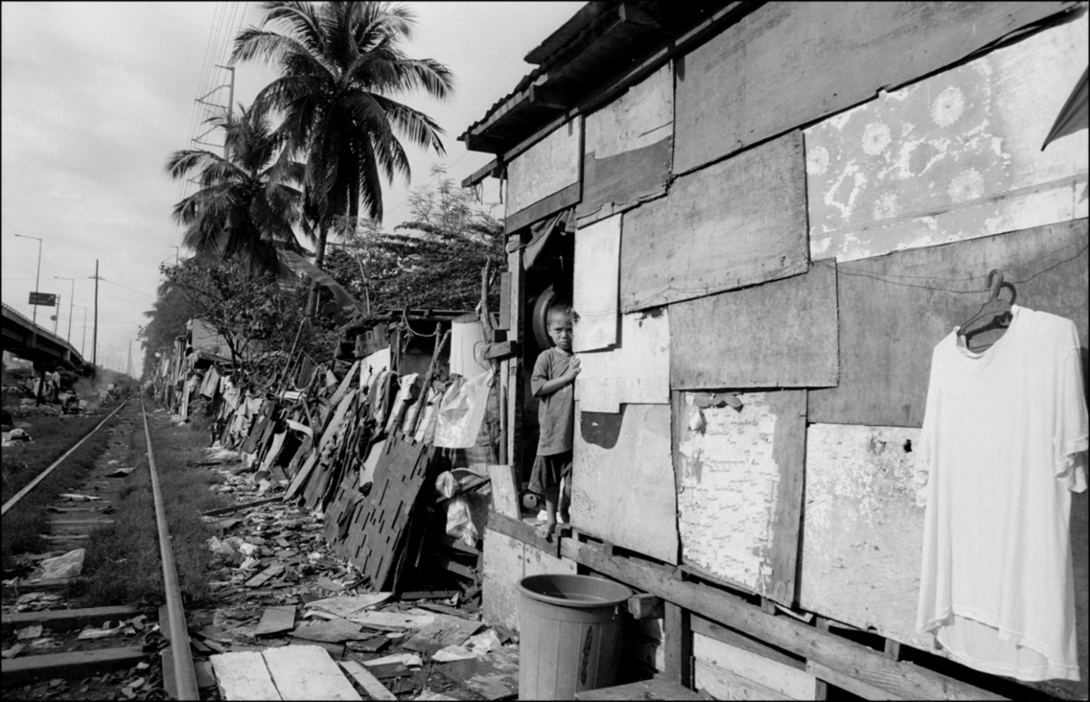 Philippines, Slums -  Boy Standing by His House, San Andreas Bridge, Manila,...