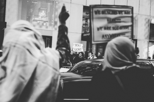    Scenes from 5th Avenue: Two  Muslim  women  attend their first  protest  after the election of  Trump  . Across the street a man holds a sign that reads "You lost". "Someone came up to me and said we were welcome - it brought tears to my eyes," said one of the friends, Mekia. "Many in my community are afraid to come out but we need to be here. We have had young ladies in our mosque have their hijab torn from their head. It's offensive and affects the entire community. I may worship a little different but I am an American," says the other friend, Bibi.Â New York City, November 13th, 2016   