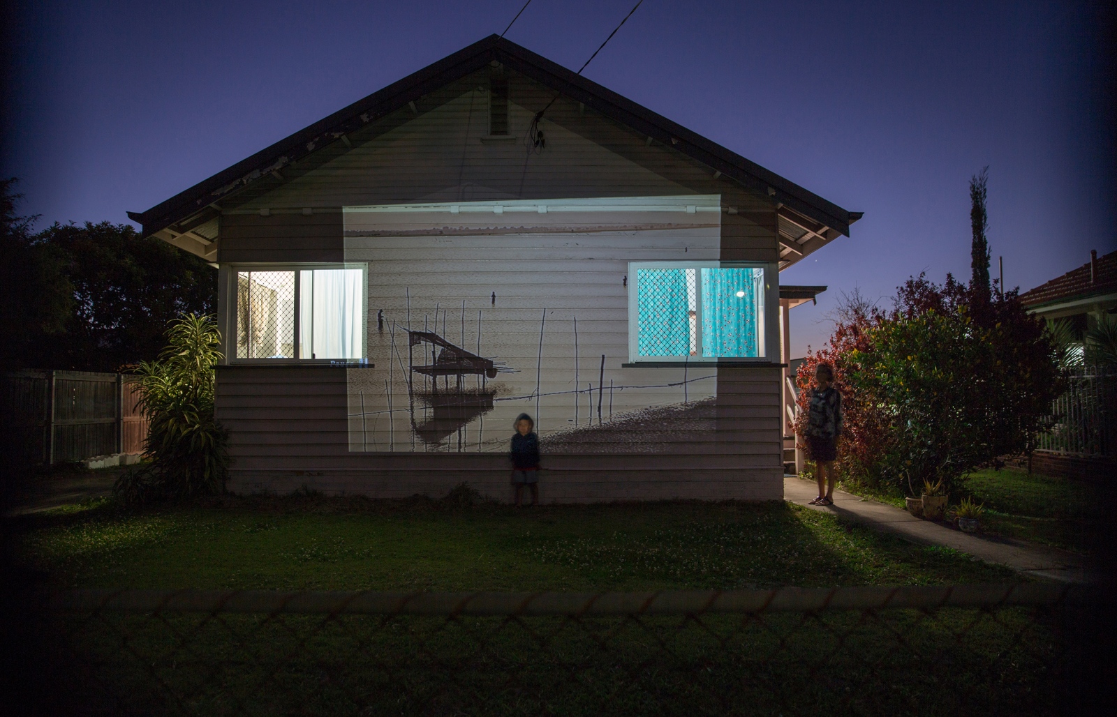 Away From Home -                 A projection of fishing families in Myanmar. This image has been projected onto...