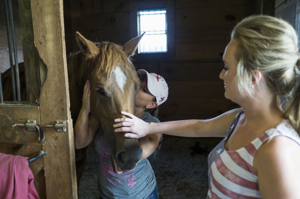  Devin Redding, with Victoria Jeddrie, giving her horse a big kiss in the stables where her horses are kept in North Carolina. August 21, 2015 (Kevin C. Downs/Cosmos) 