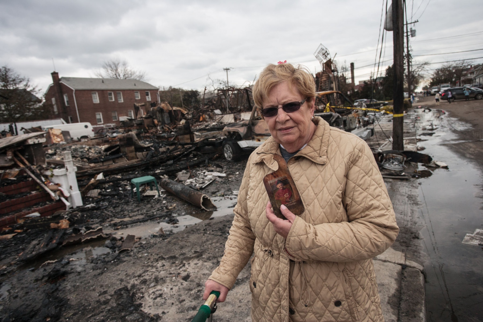 The Rockaways After Hurricane Sandy - Lorraine O'Neil, age 60, stands in front of her...