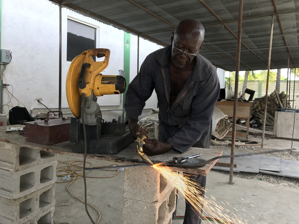 A man works iron to build the ho_Haiti, Thursday, March 16, 2017.