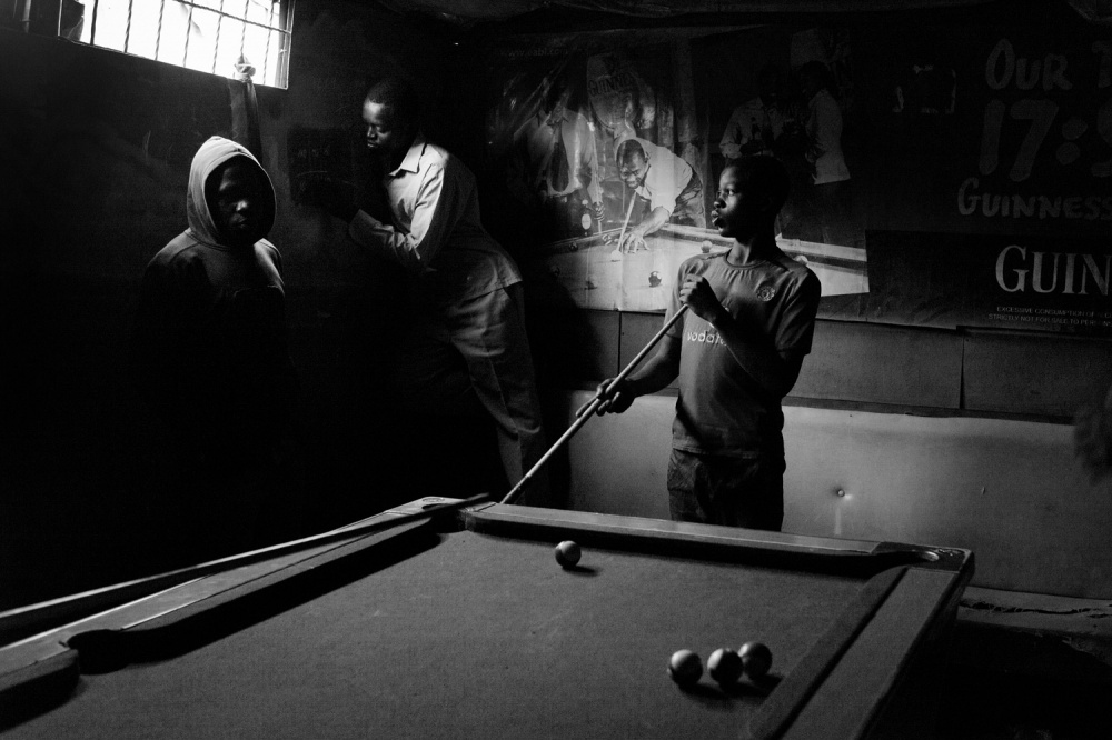 Youth play the popular billiard...ductive outlet for adolescents.