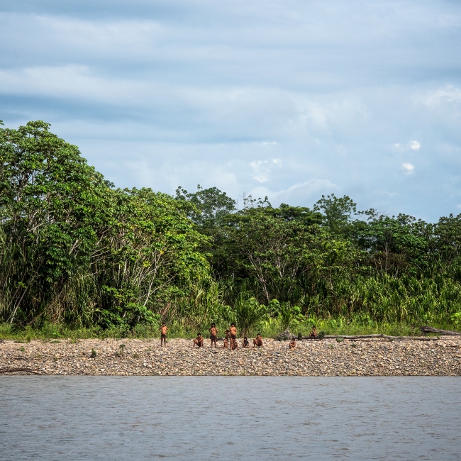 Members of the isolated Mashco-...act on the Madre De Dios River.