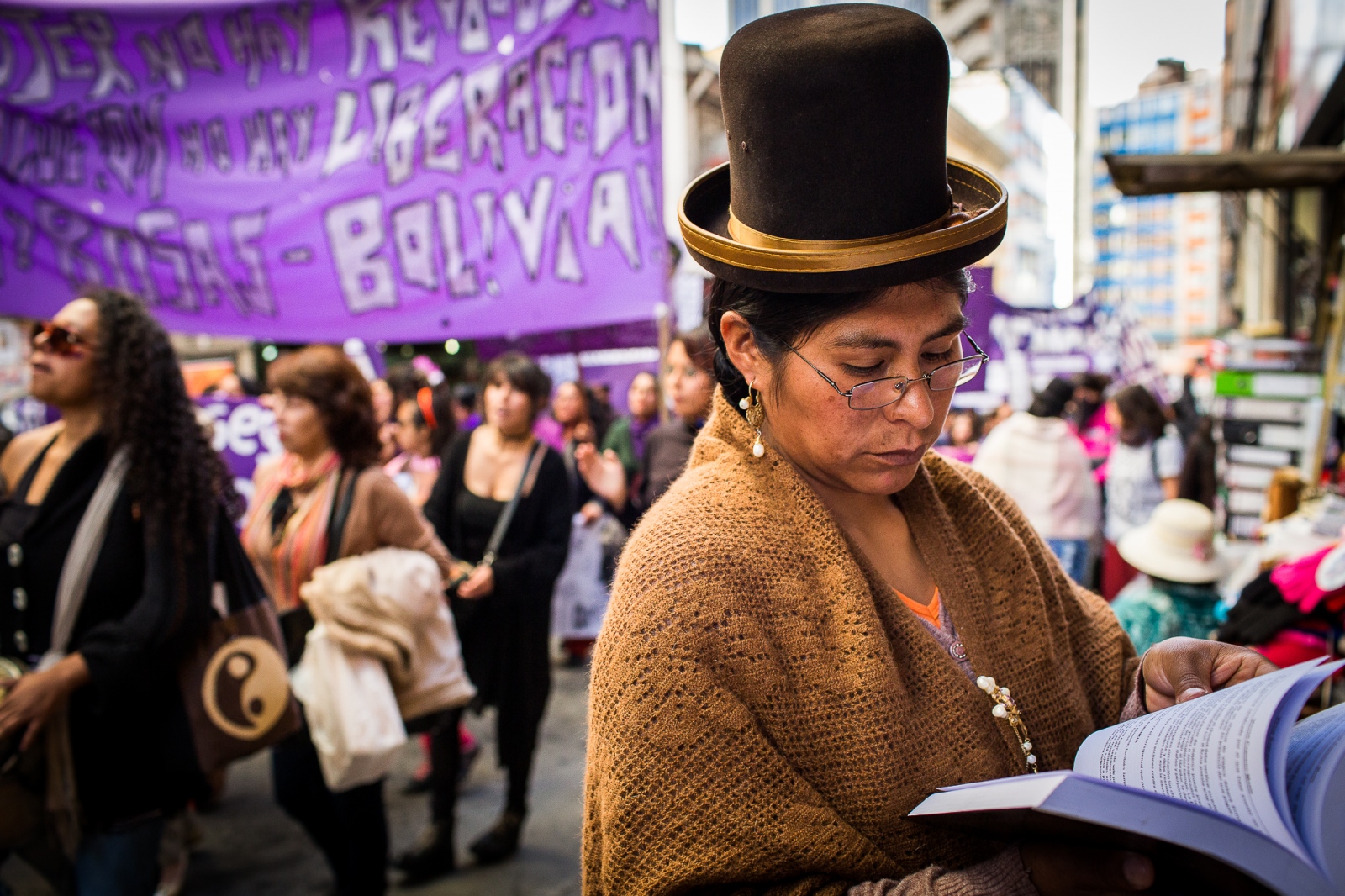  A "cholita" reads a book next to a newsstand during an International Women Day march in La Paz. Despite all the progress women have made over the last decade, the fact remains that women—and especially indigenous women—are far from equal in Bolivian society. Issues like domestic violence and access to education are still major problems that will require further investment and dedication from Bolivia’s government as well as from society at large. 