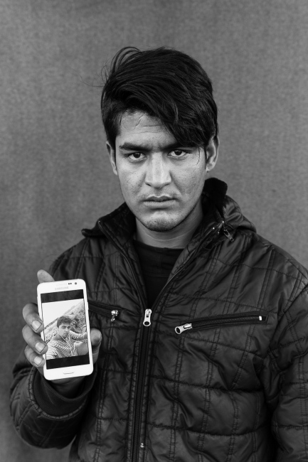 Naingal (18) holds a photo of ...found 2 days later in Hungary. 
