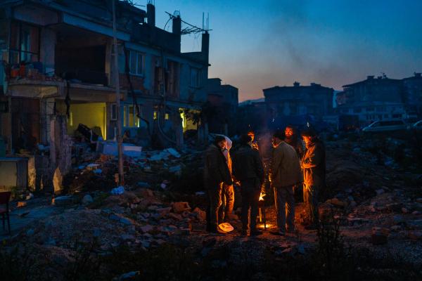 Image from Selected Works - Ismail and his family stand near the fire, waiting for...