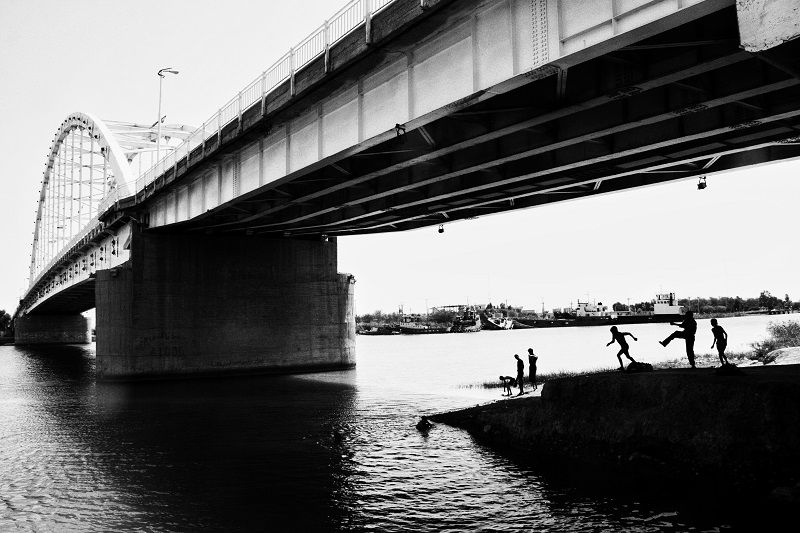 This city has no heroes - Young people are swimming in the Karun River. at this...