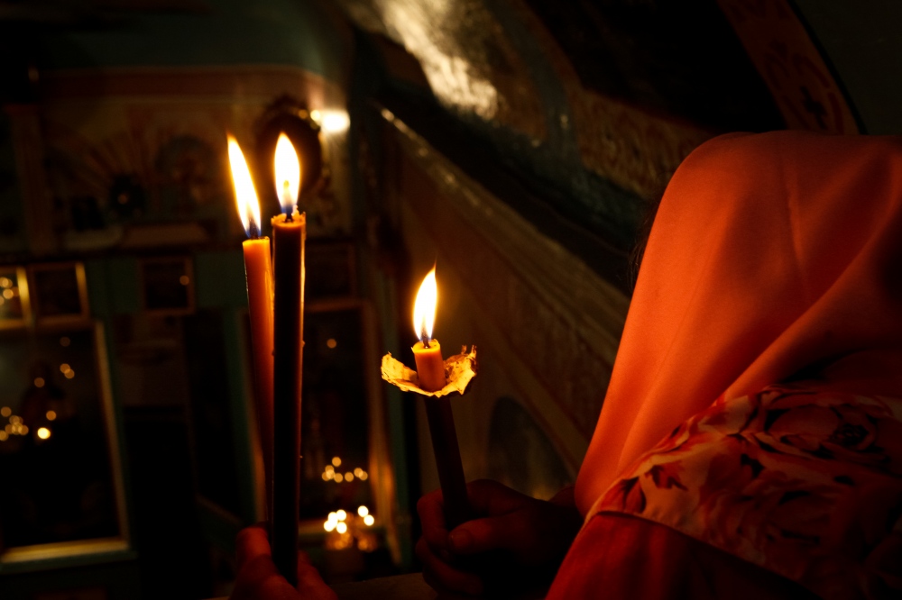 Candles lite during an early morning orthodox mass.