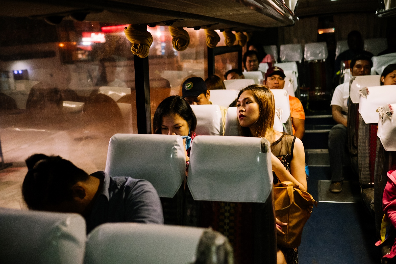 Bessie, (Rachel), 32 years old, on her way to work. &ldquo;One &nbsp;of the reasons why I like to work at night is the fact I face less traffic on my commute. During the day the buses are so crowed that you can barely find a seat.&rdquo; Manila, Philippines. 25th April 2016.