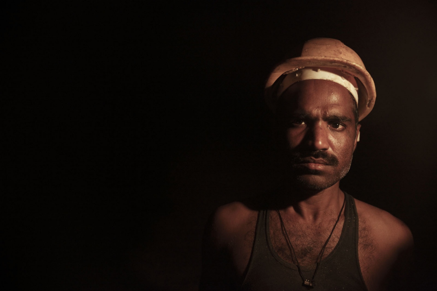 PAKISTAN'S SALT MINES -  A salt workers in the darkness of the Warcha salt mine....