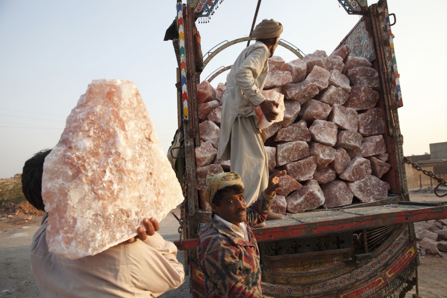 PAKISTAN'S SALT MINES -  Men load a truck with salt from Khewra Salt mine to be...