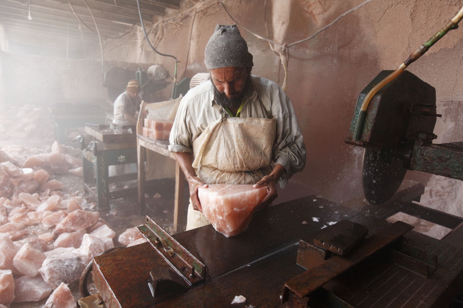 PAKISTAN'S SALT MINES -   In a salt cutting factory near Kalabargh, a man from...