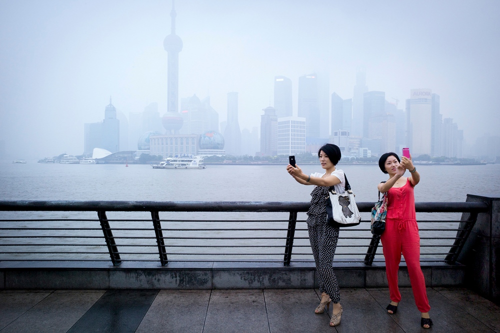 Girls take selfie in front of L... skyline, Shanghai, China. 2012