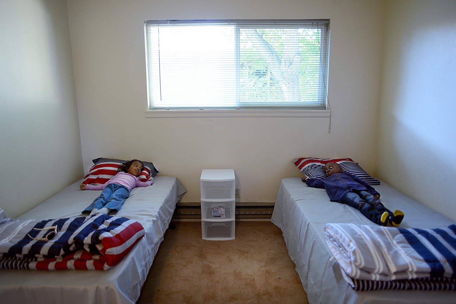 Welcome to Twin Falls, Idaho - Mudather Geddo Giro and his friend try out the beds in...