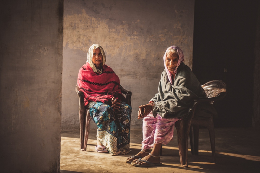 Women sit outside of a medical camp near Chitrakoot, India.