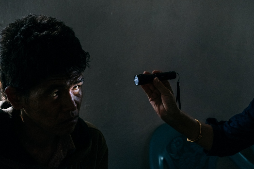 Image from FINDING LIGHT IN THE DARKNESS - Pasang Sherpa, 28 yrs. old undergoes a vision test at an...