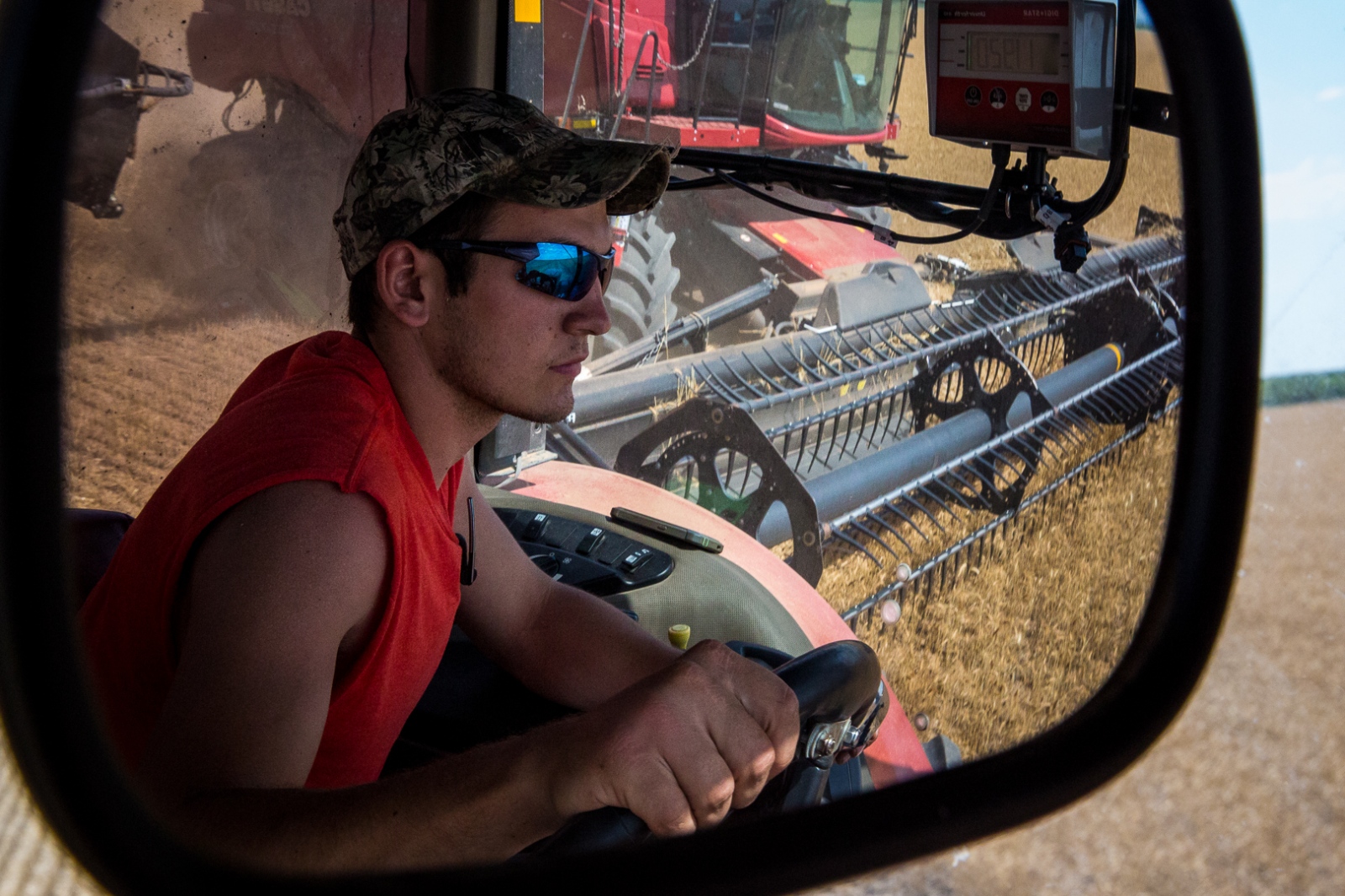 Harvesters -  Alan Stoner, 21, drives a grain cart to collect...