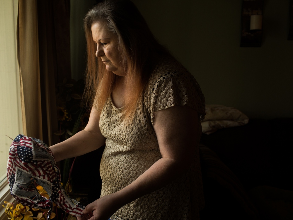 Image from CALL HER ALASKA - Tina Cramer Showers holds a headscarf she was given when...