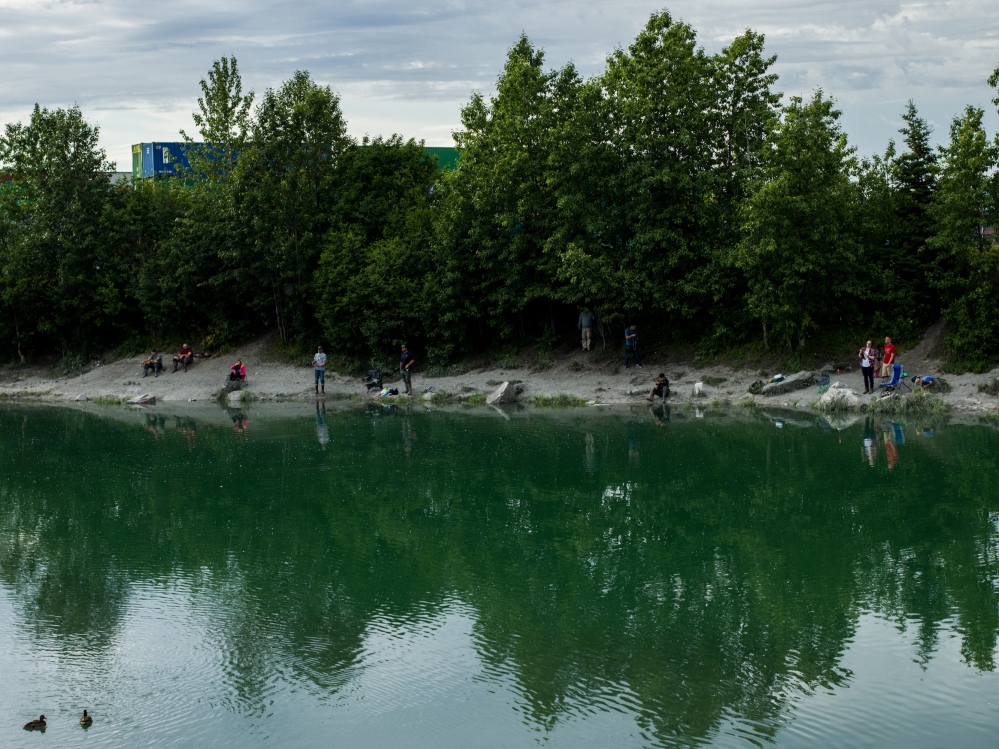 Image from CALL HER ALASKA - People fish in Ship Creek during high tide on Thursday,...
