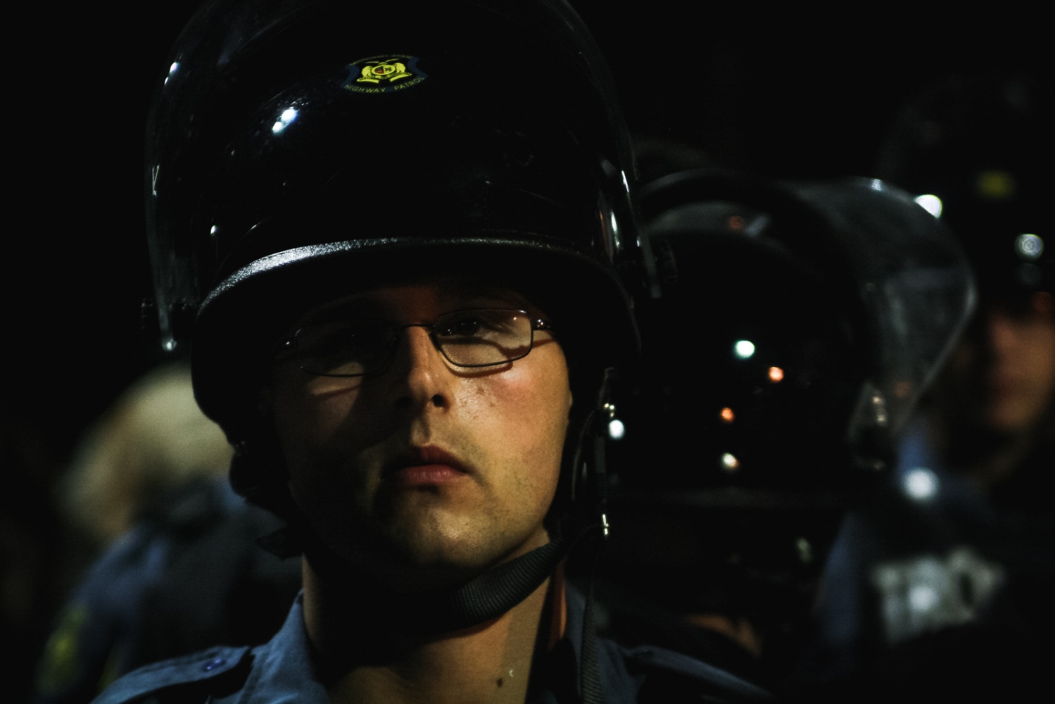 Ferguson October - A Ferguson police officer in riot gear stands in...