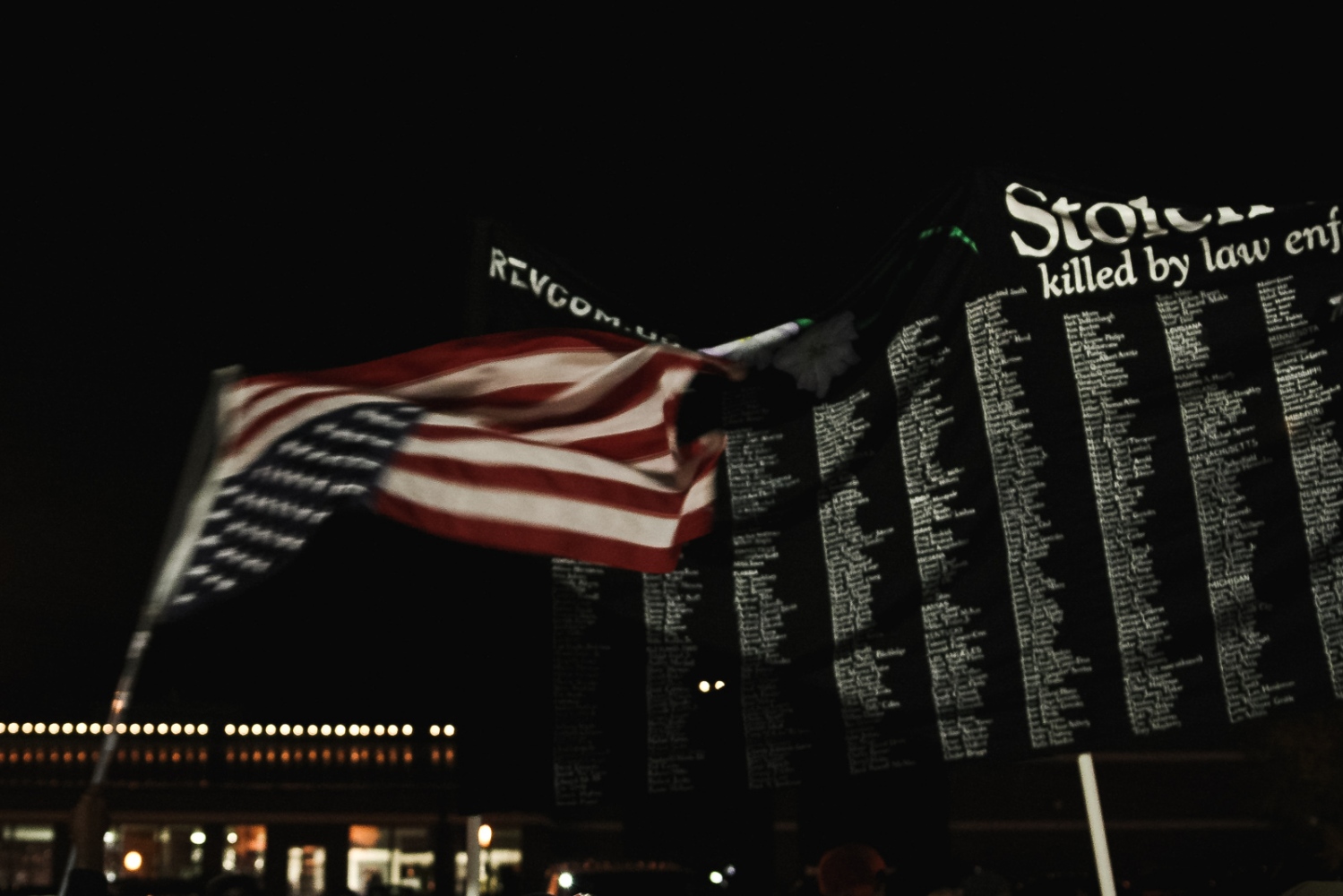 Ferguson October - An activist waives an upside down U.S. flag next to a...