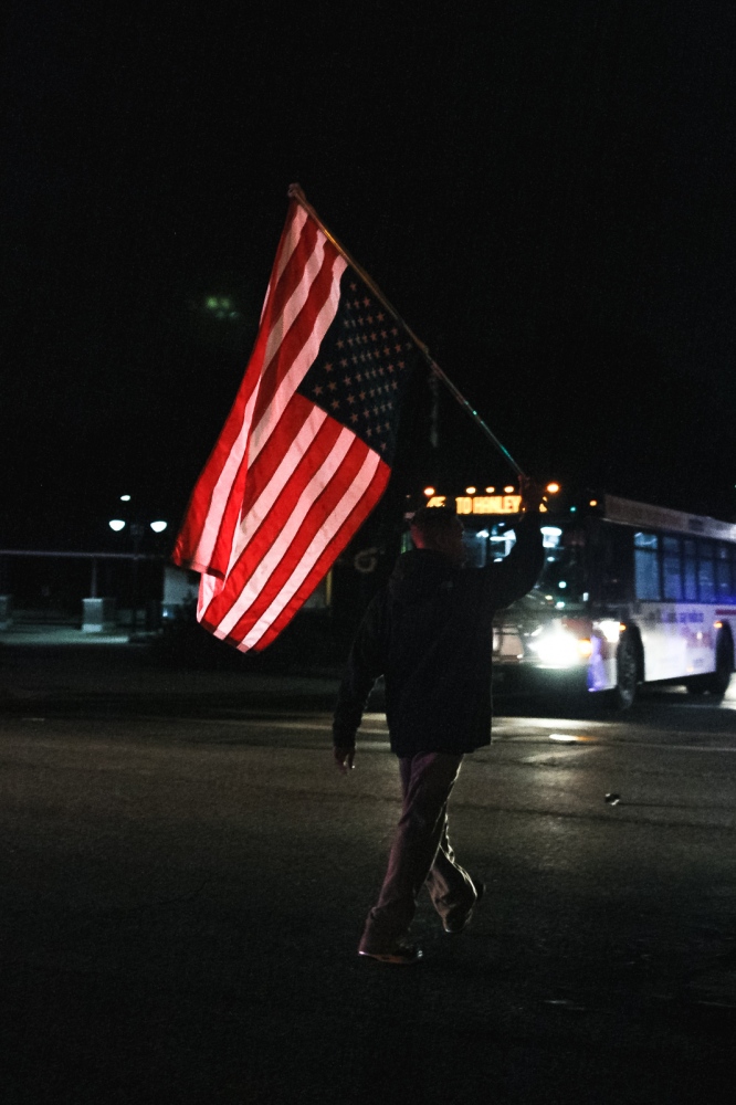 Ferguson October - An activist blocks a Ferguson intersection while holding...