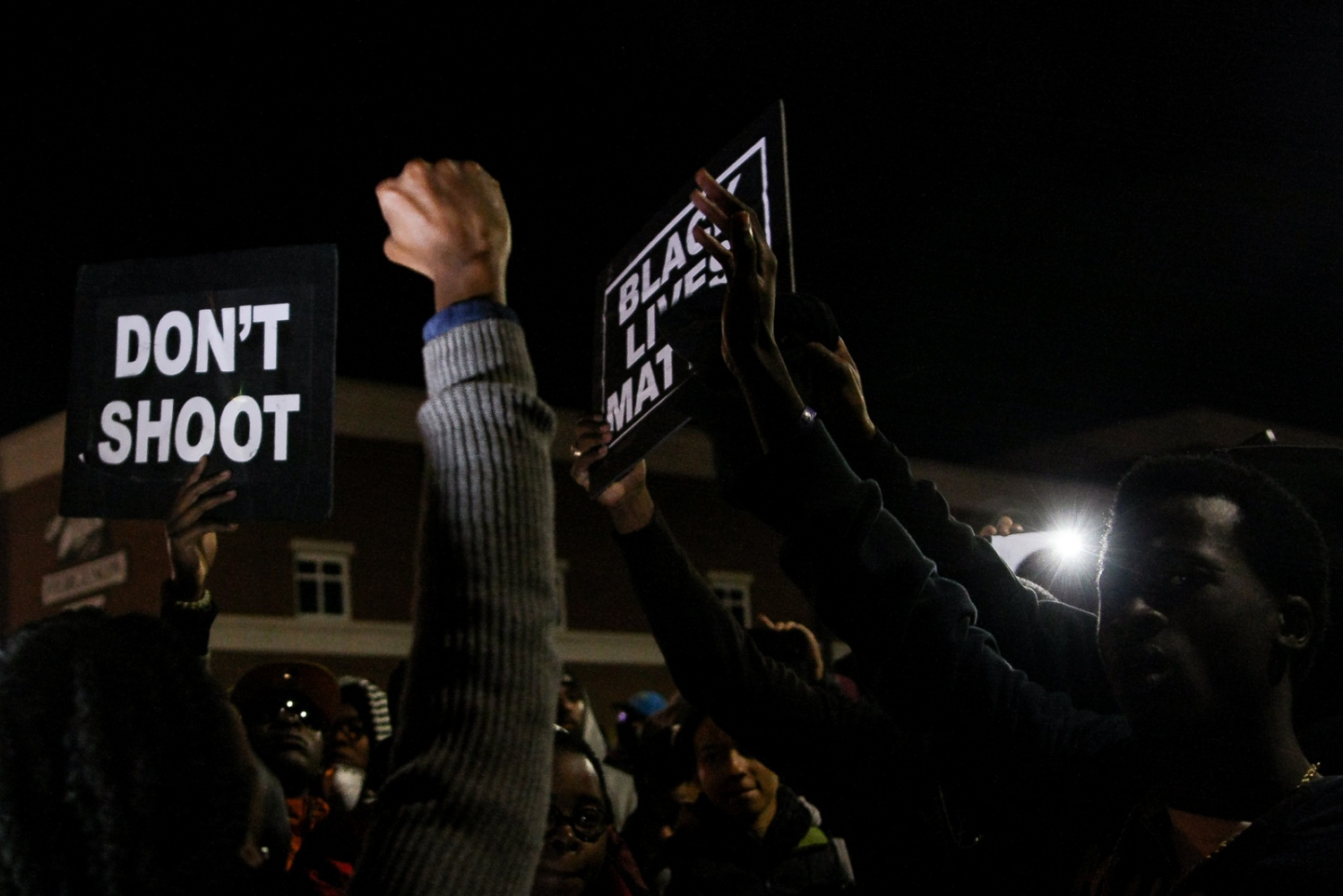 Protestors gather in front of the Ferguson Police Department.