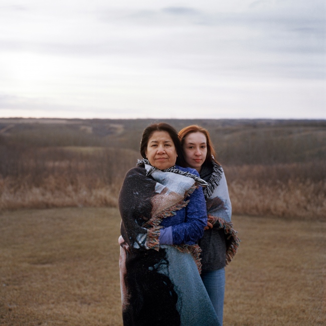 Gwenda Yuzicappi, 51 and her adopted granddaughter, Leslie Maple, 16 are pictured outside of their home on Standing Buffalo First Nation northeast of Regina, Saskatchewan. Gwenda&#39;s daughter and Leslie&rsquo;s caregiver, Amber Redman, went missing in 2005 until her remains were located in Little Black Bear First Nation almost three years later. Amber was beaten to death by two men after she was convinced to go to their house during a late night out. Leslie was only 5 years old at the time. &ldquo;[Leslie] was Amber&rsquo;s way of seeing what was going to happen to her. Leslie was my strength [when Amber went missing], she would soothe me and pet my hair. If it wasn&rsquo;t for Leslie&hellip;I don&rsquo;t know where I&rsquo;d be.&rdquo; This was Leslie&rsquo;s first time discussing the murder of Amber, she faces daily reminders while going to school with the daughter of one of Amber&rsquo;s killer&rsquo;s.