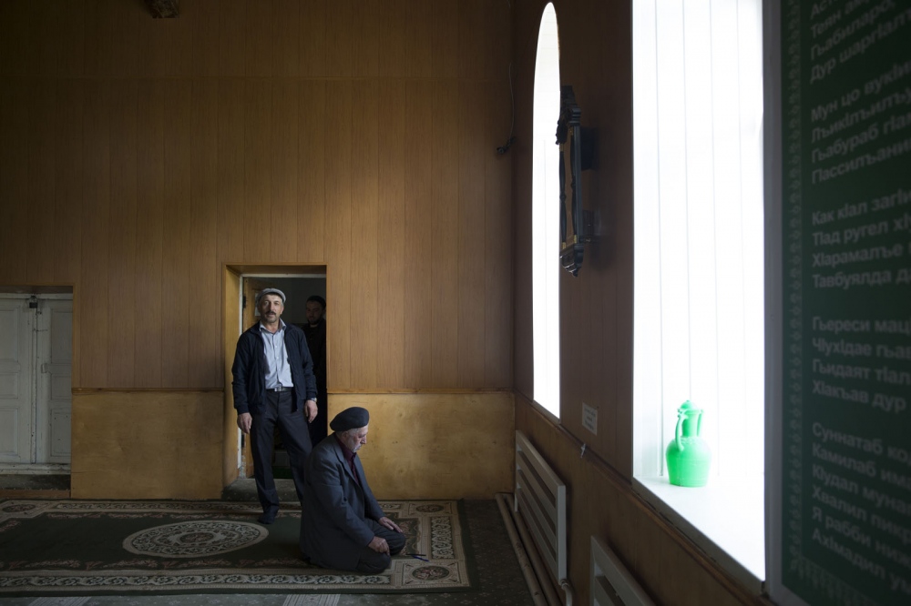 Muslim men from the village of Theletl take Friday prayer in the local village Mosque. Dagestan, Russia