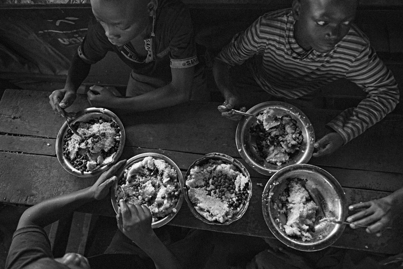Former child soldier boys, some as young as 10, eat lunch at the BVES transit center in Bukavu,...