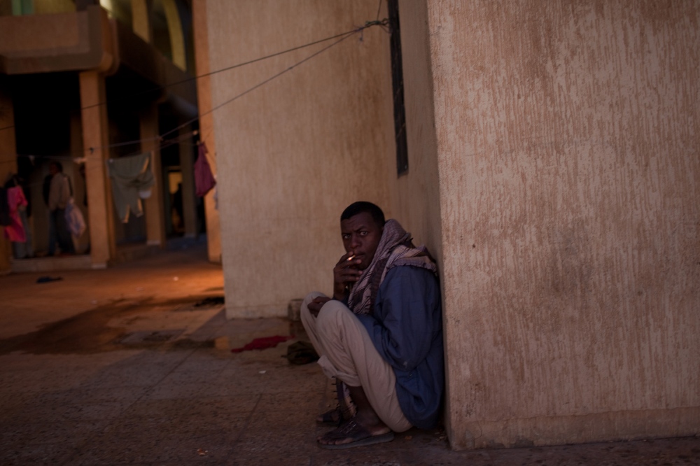 A migrant smokes a cigarette in...uthern Libya on March 7, 2012. 
