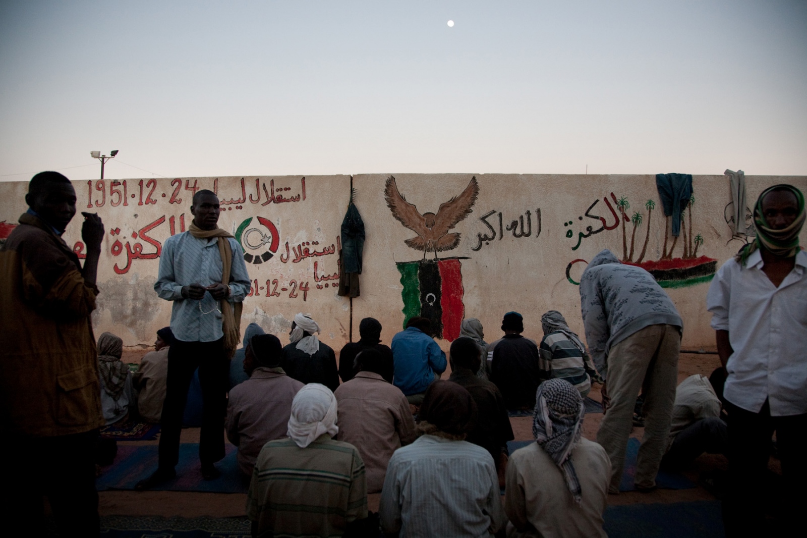 Libya: Migration Crisis - Migrants prepare for evening prayers at the detention...