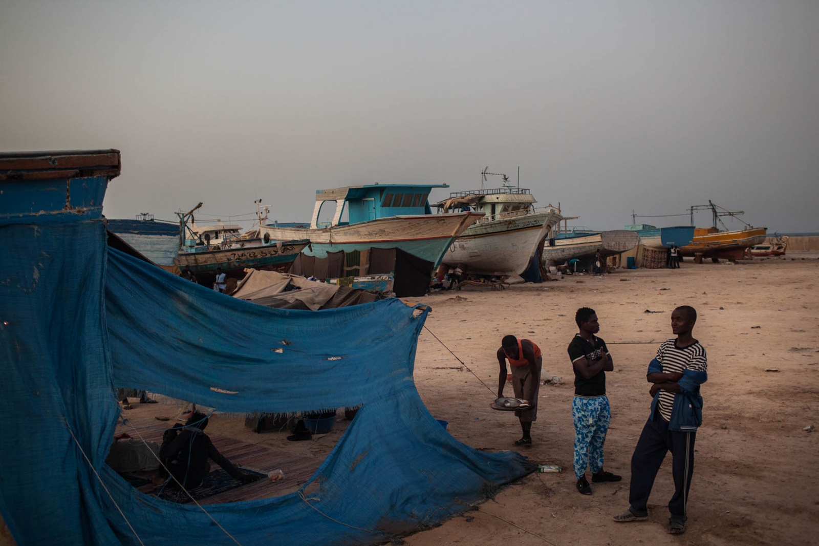 Libya: Migration Crisis - Young men at a fishing port in Tripoli on September 18,...