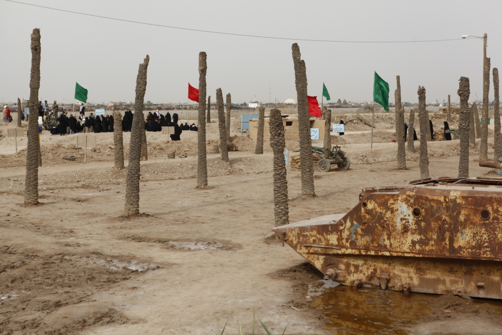 the burnt palm trees remained from Iraq attacks to Iran.